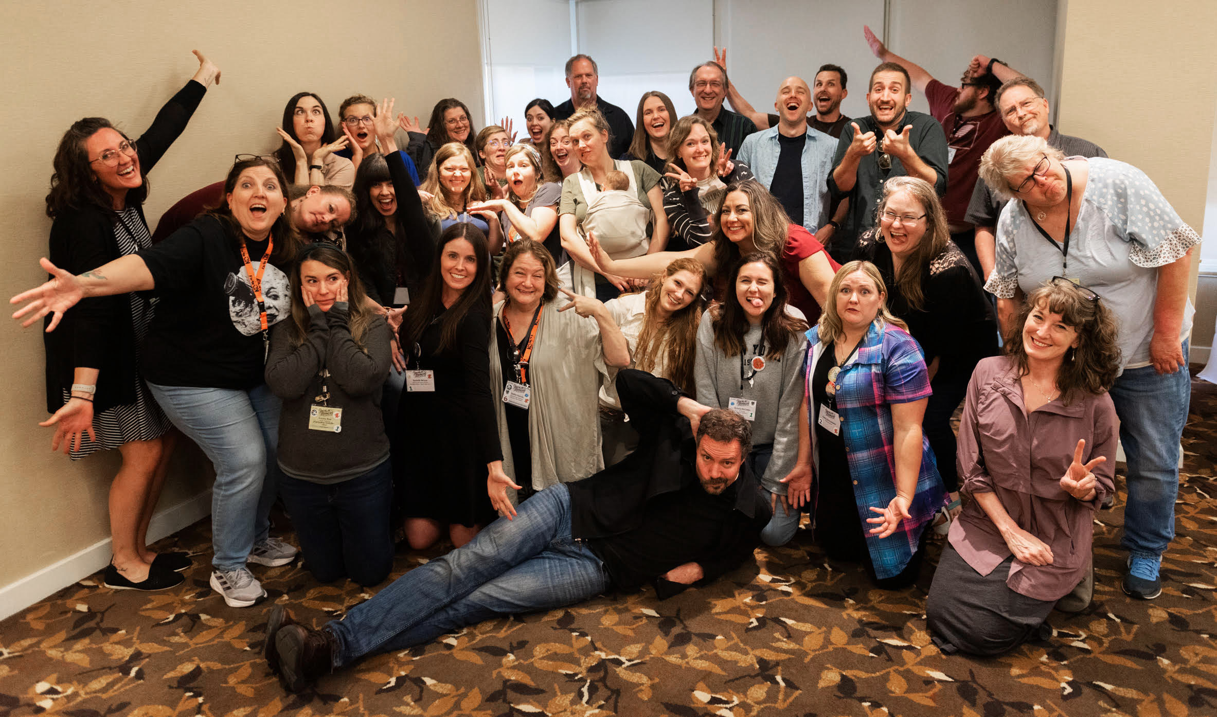 Enclave Publishing group photo at Realm Makers 2023 (silly version!)